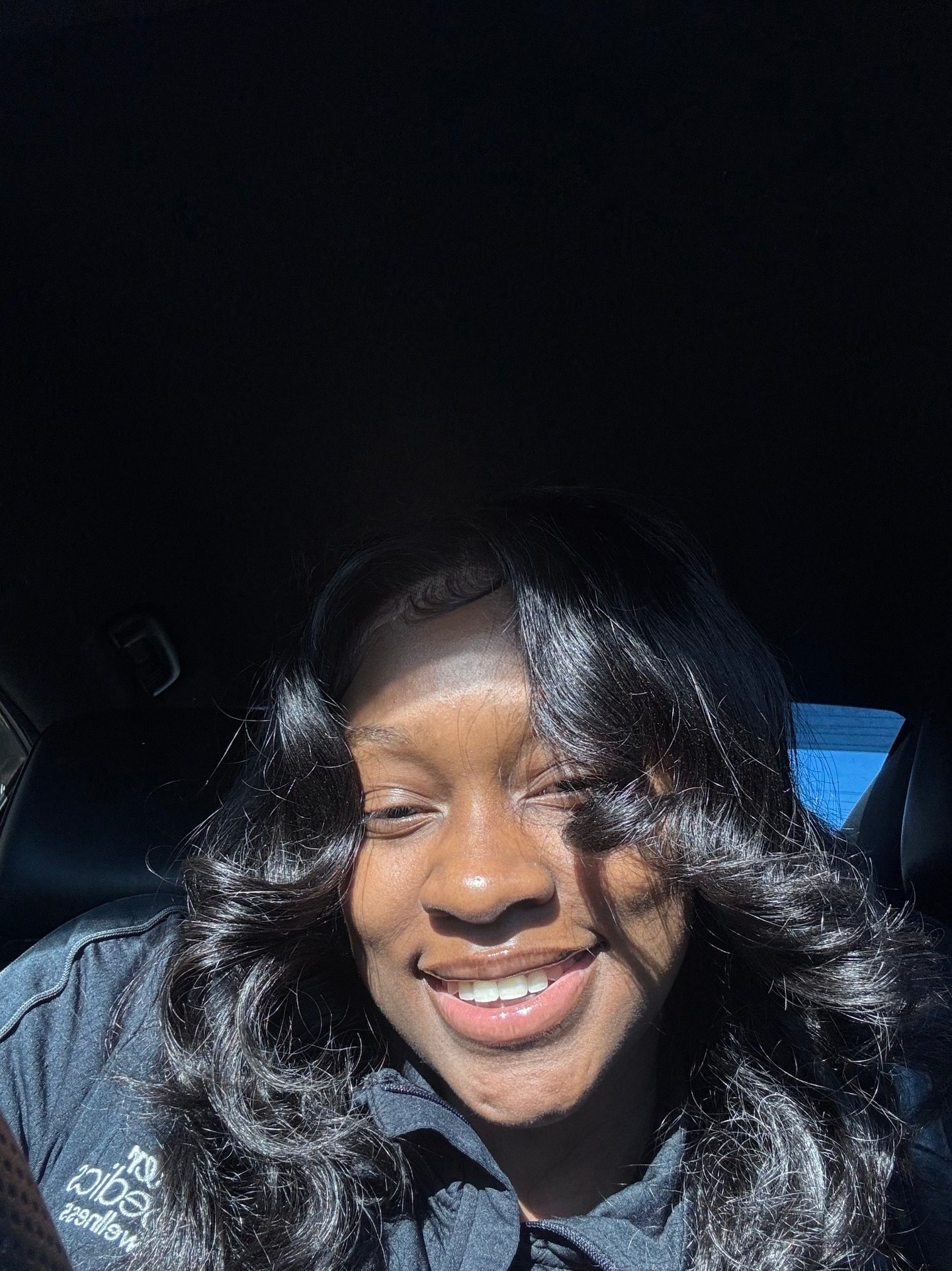 Dyimond's car selfie, hair down, big smile