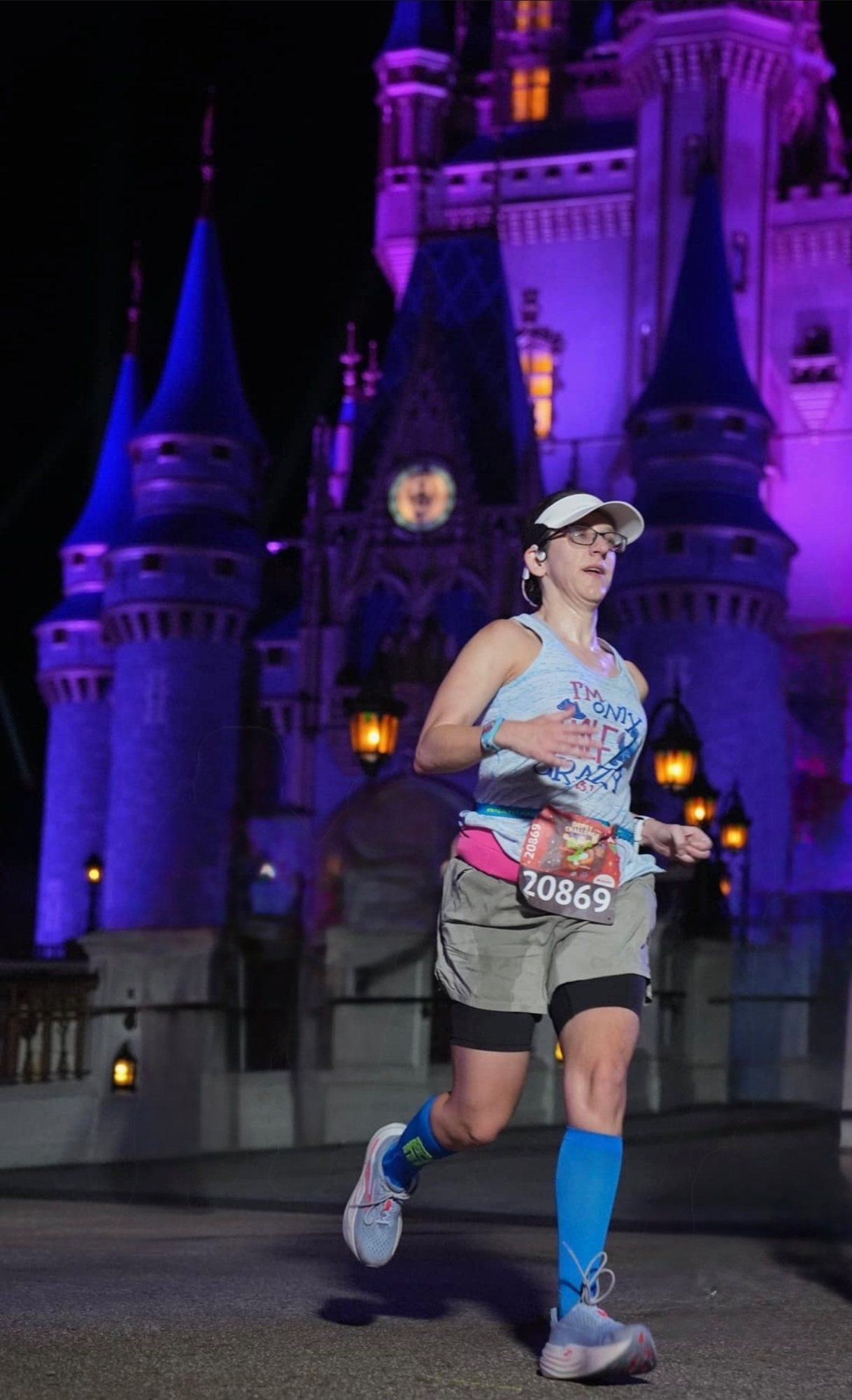 Elizabeth running past the castle at night during the Walt Disney World Marathon