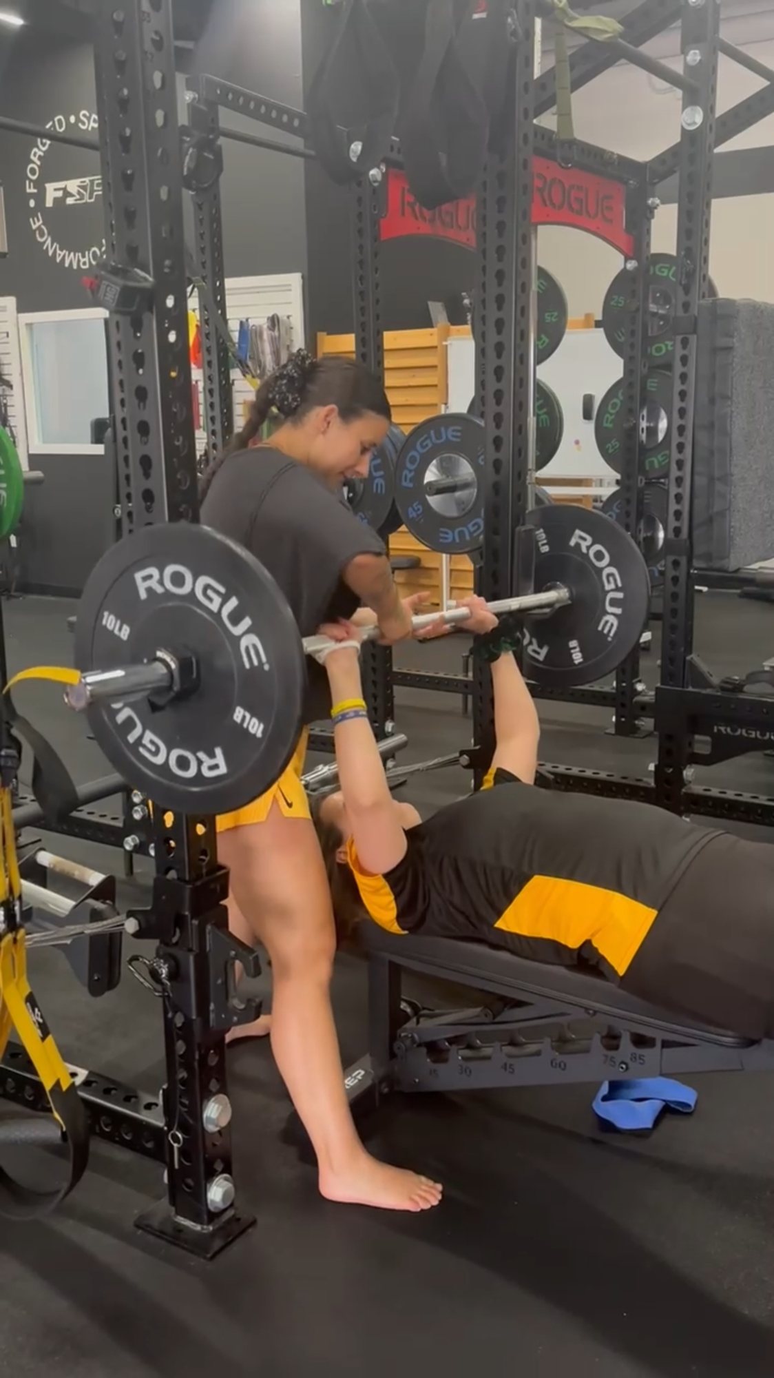Madison spotting an athlete on the bench press