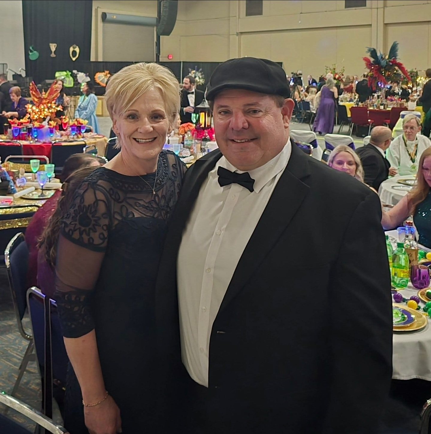 Coach Paul in a flat cap and bow tie at a gala