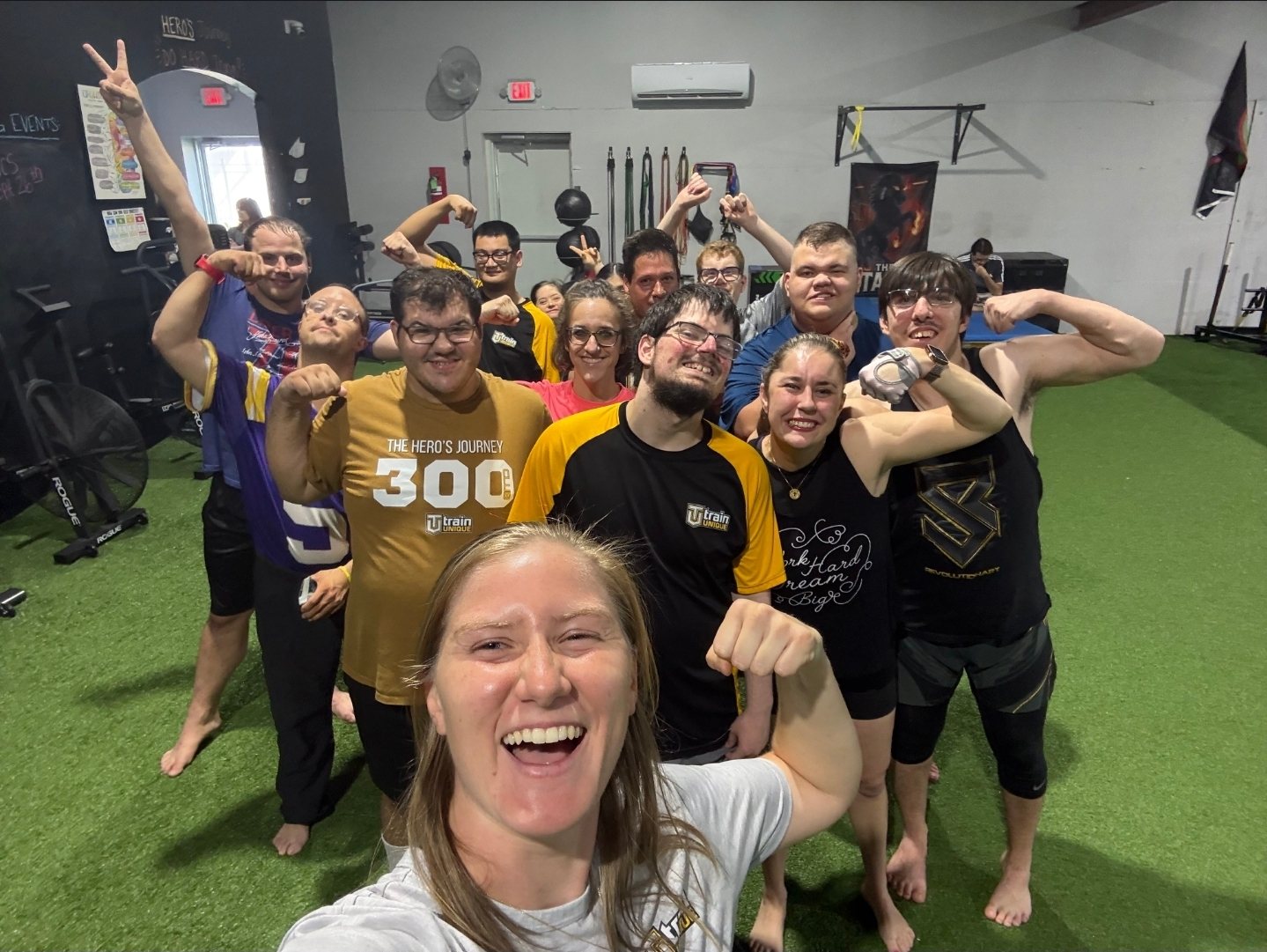 Shannon's selfie with a full group of athletes flexing behind her on the turf