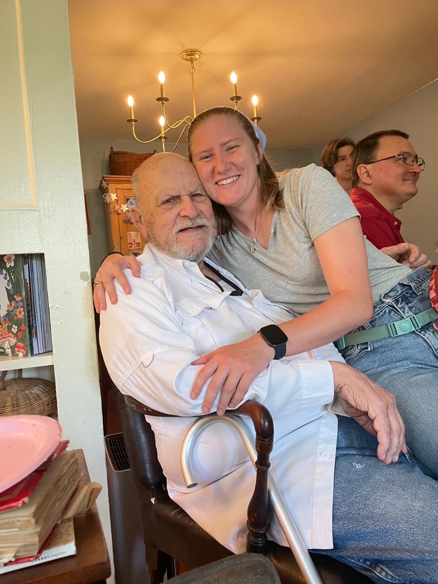 Shannon with her arm around an older man at a gathering