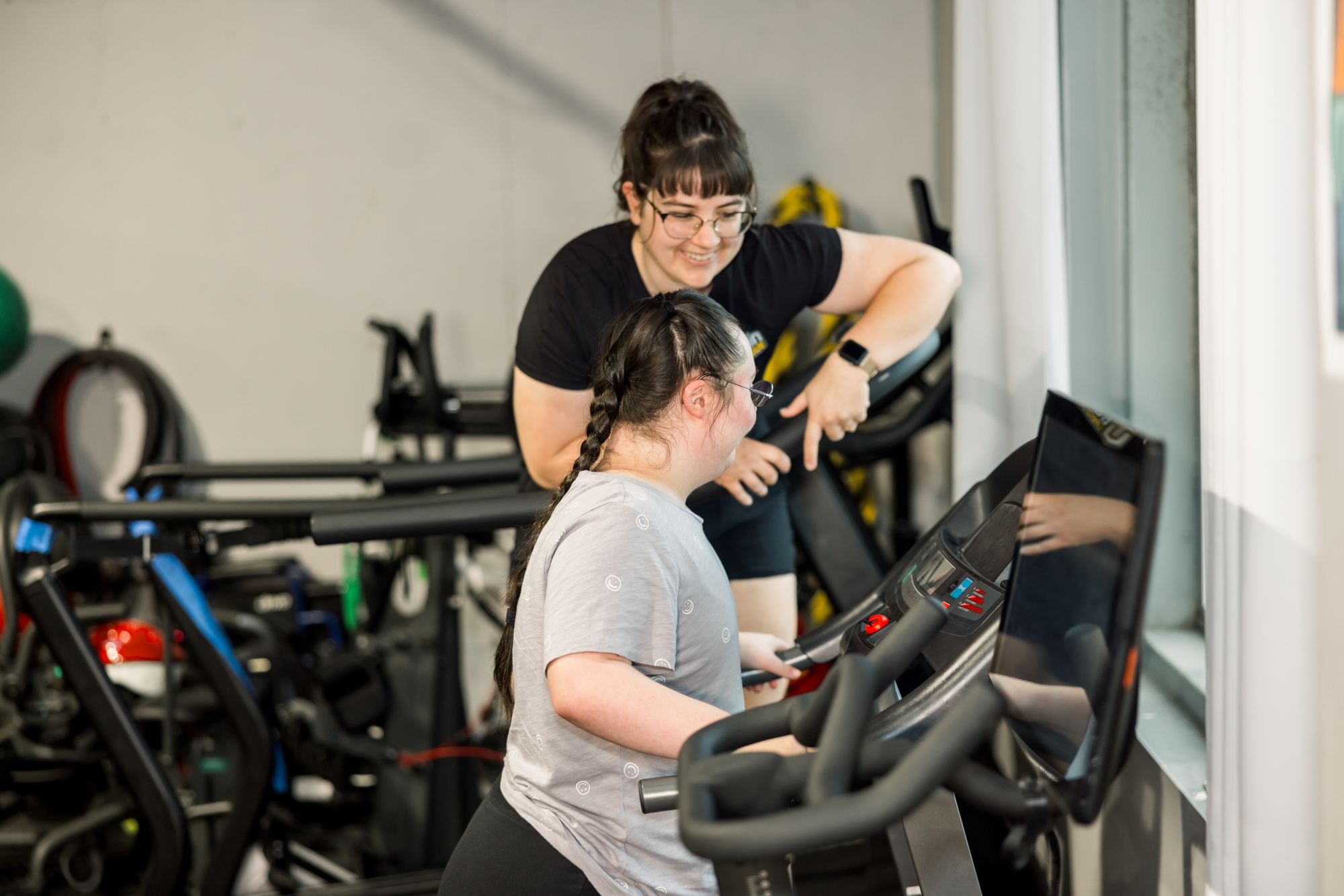 A coach at the treadmill with her athlete