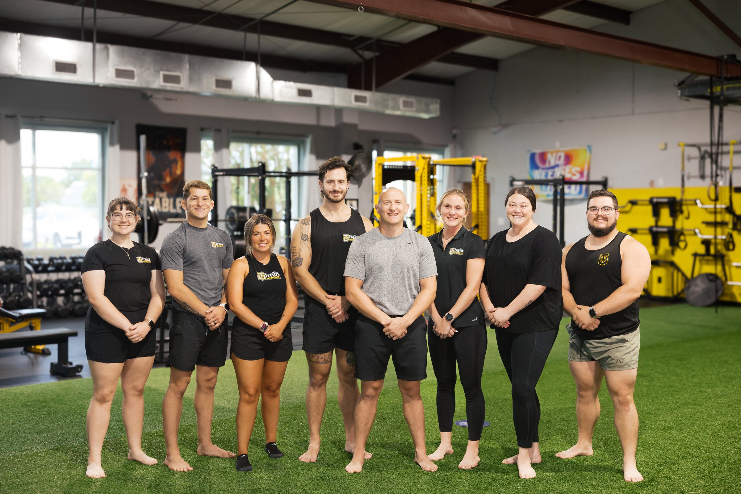 The Train Unique coaching staff on the gym floor