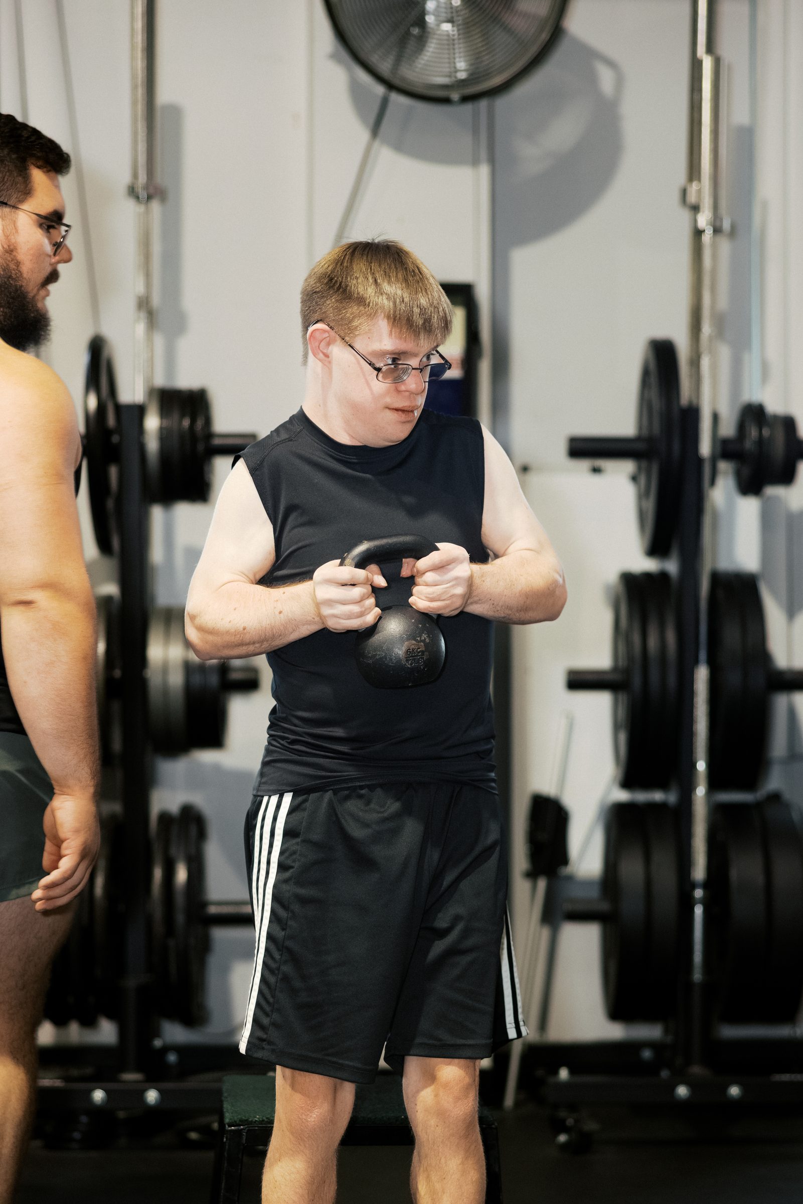 A young man setting up with a kettlebell