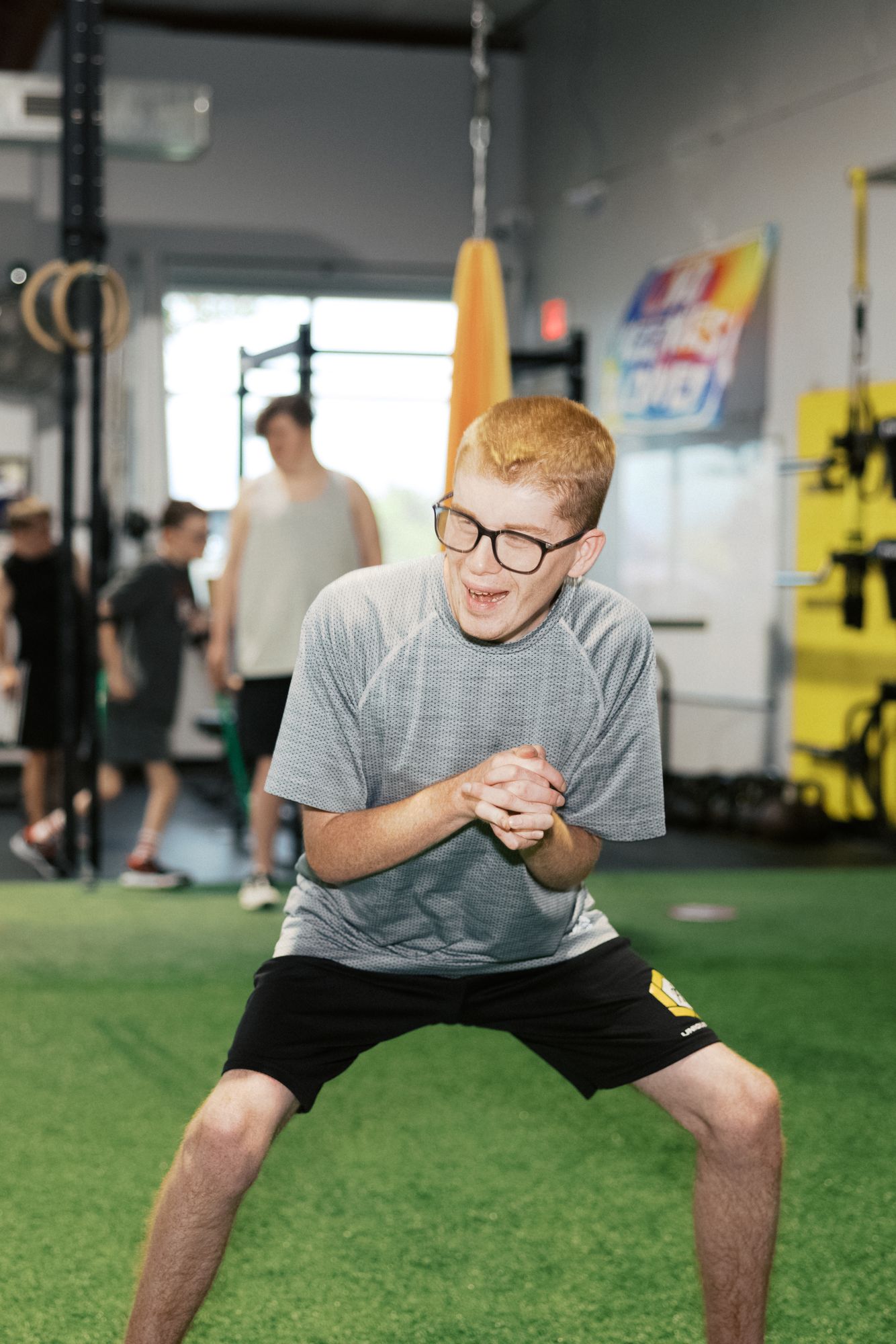 A young athlete holding his squat