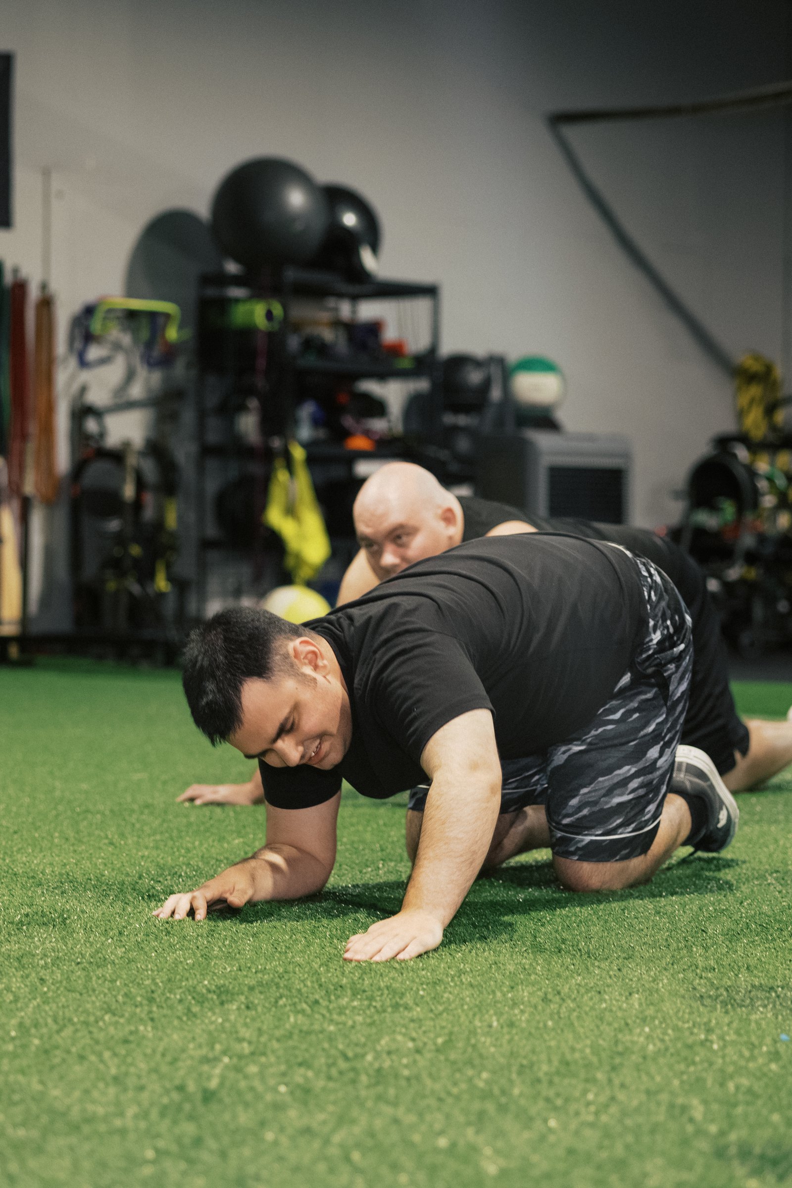 An athlete bear-crawling across the turf