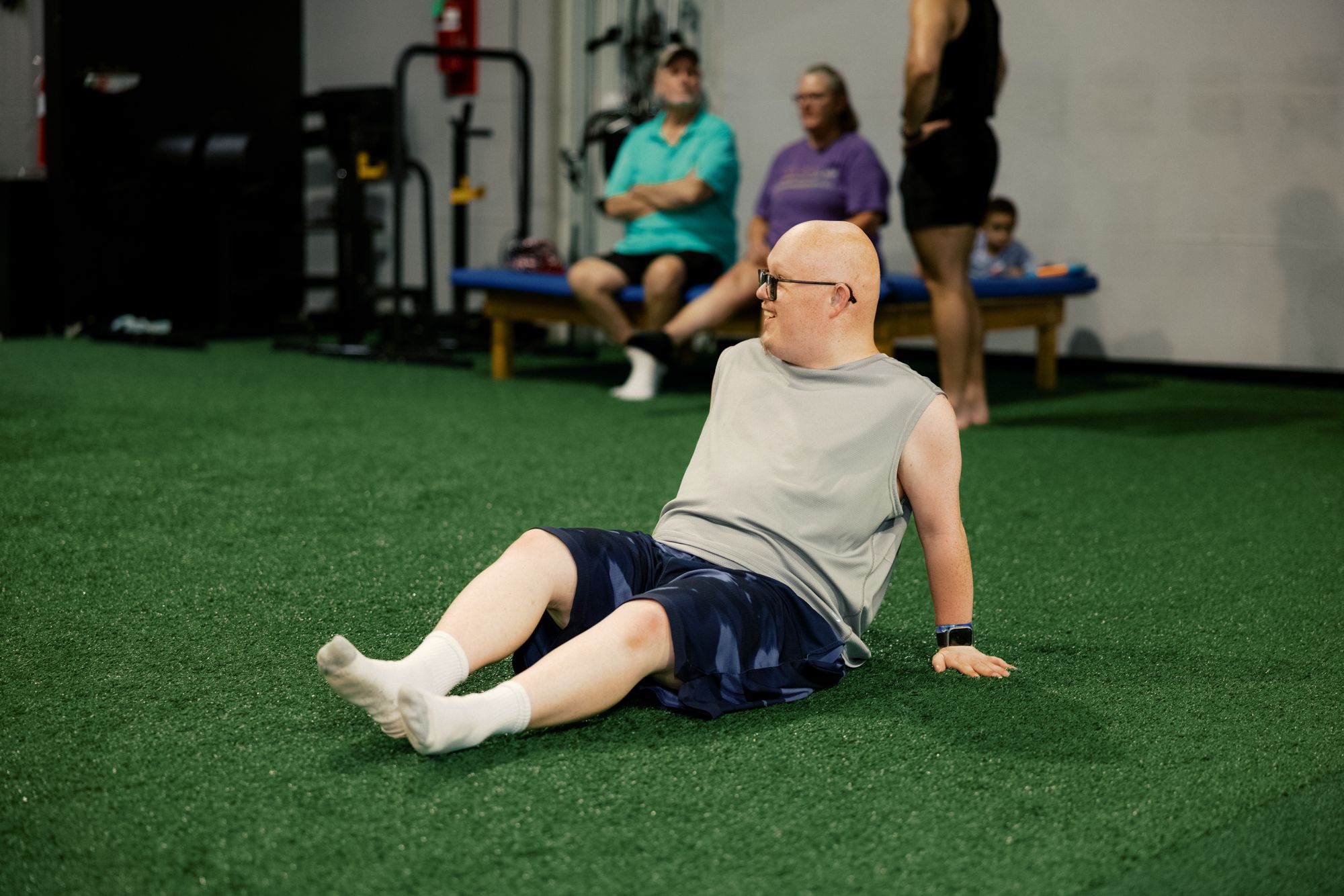 An athlete working get-ups on the turf