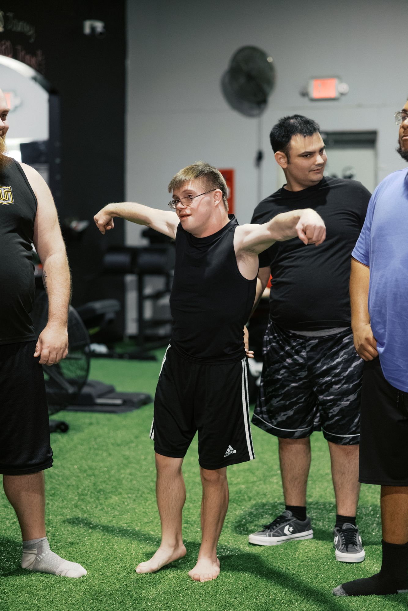 Two athletes trading moves, coach alongside