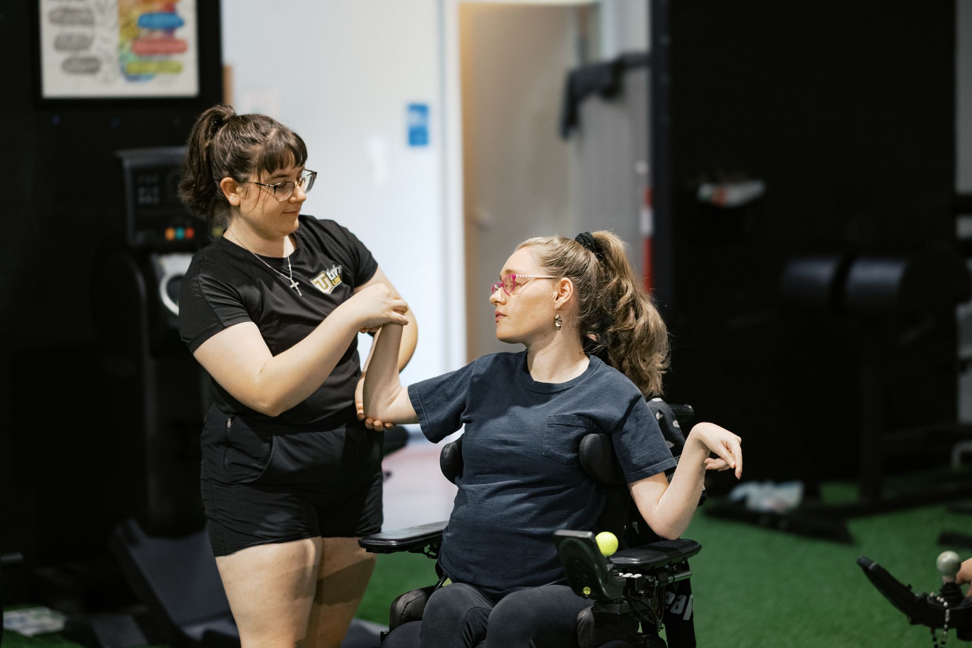 A coach and athlete working through a seated drill