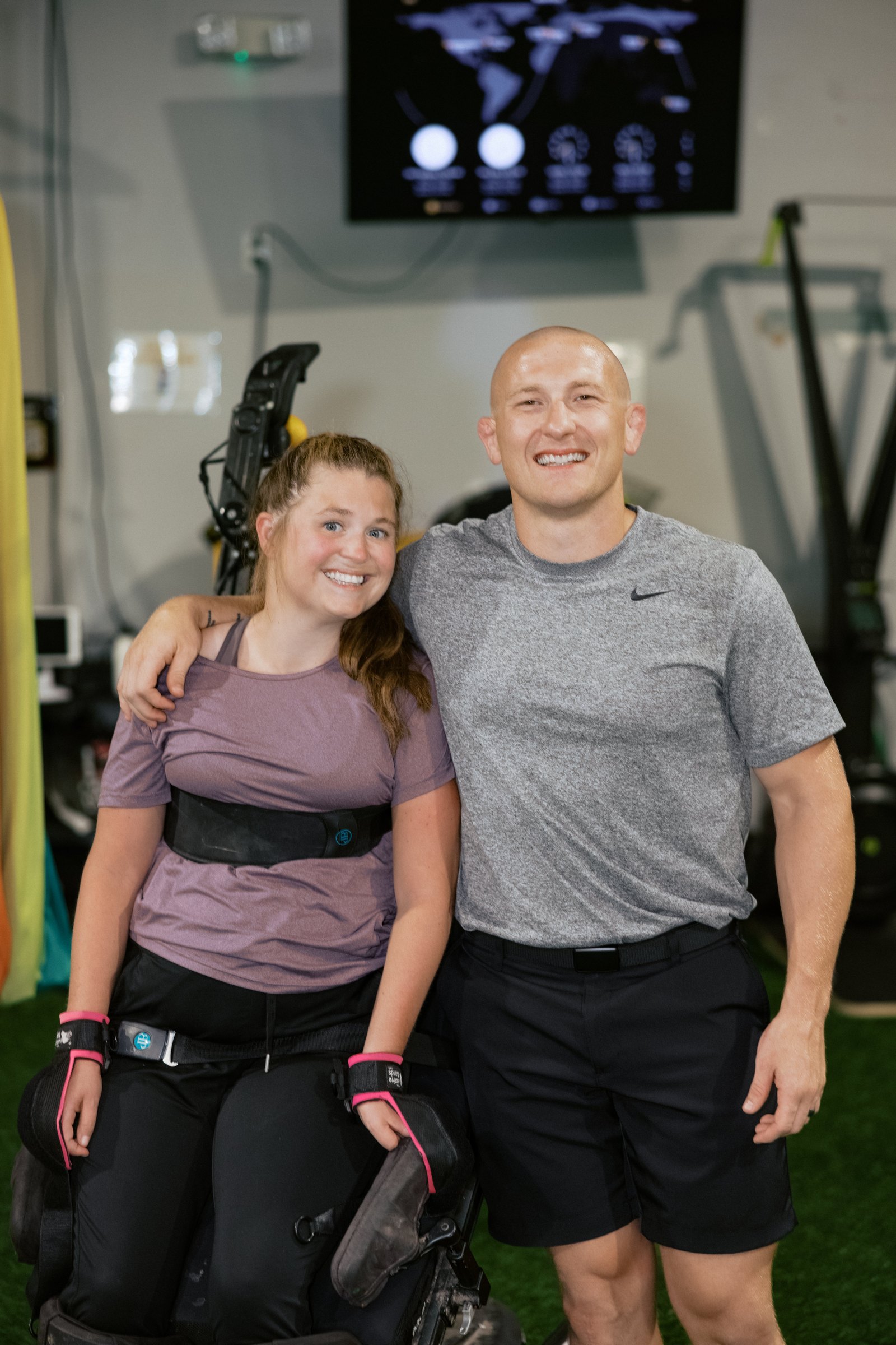 An athlete and her coach on the gym floor