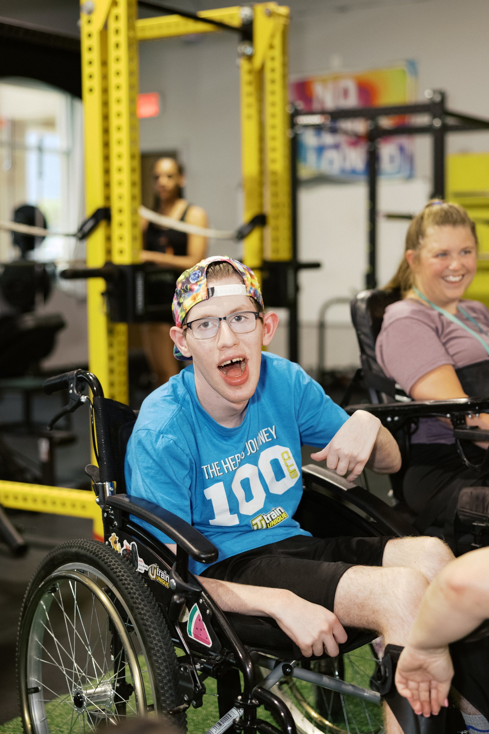 A young athlete grinning in his 100-session shirt